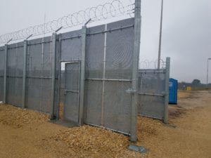 The end of 2 parallel sections of high security fence