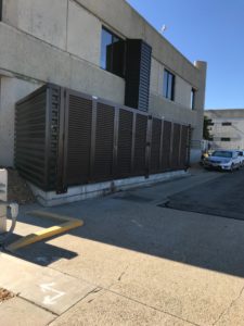 A PalmSHIELD louvered fence enclosure on the side of a City of Los Angeles Department of Water and Power building